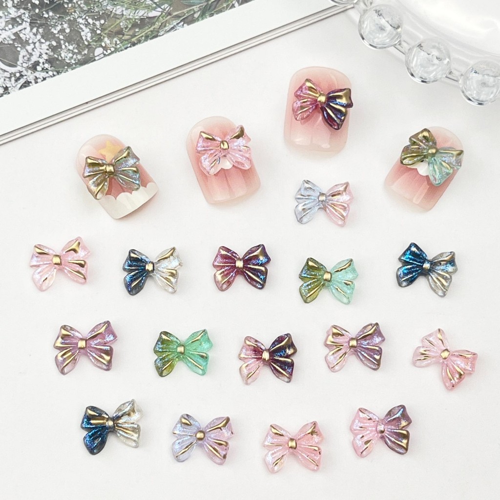 ฟอยล์สีทองวาดทองกุทัณฑ์เครื่องประดับแต่งเล็บขายส่งออโรร่าวิจิตรกระพริบน้ําแข็งใสโบว์ผูกเรซิ่นทําเองสวมใส่เล็บอุปกรณ์เสริม