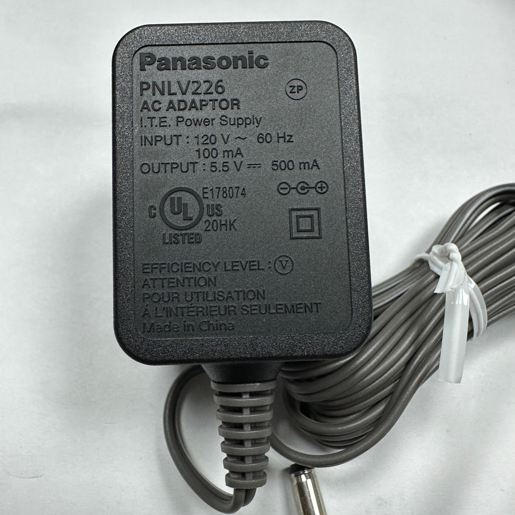 Panasonic แหล่งจ่ายไฟย่อยเฟรมโทรศัพท์ไร้สายดิจิตอล 5.5V0.5A PNLV226 อะแดปเตอร์ 110-240v