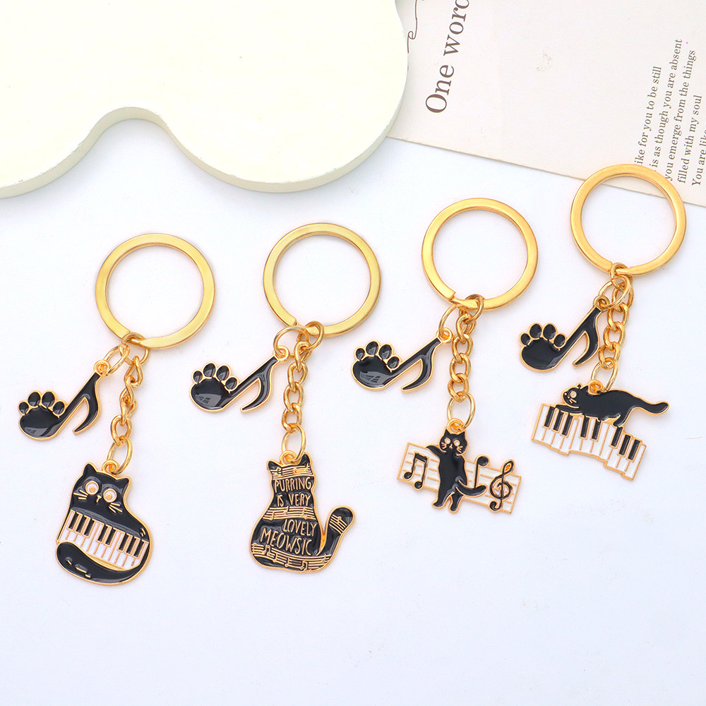 น่ารักเปียโนลูกแมวพวงกุญแจแหวนประณีตโลหะเพลงหมายเหตุแมวพวงกุญแจคิวการ์ตูนสัตว์กุญแจรถโฮลจ์กระเป๋าจี้ของขวัญ
