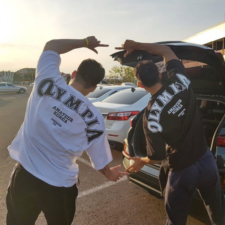 เสื้อยืดแขนสั้นกีฬา OLYMPIA เสื้อผ้าออกกําลังกายเหล็กผ้าฝ้ายแท้ครึ่งแขนหลวมขนาดใหญ่