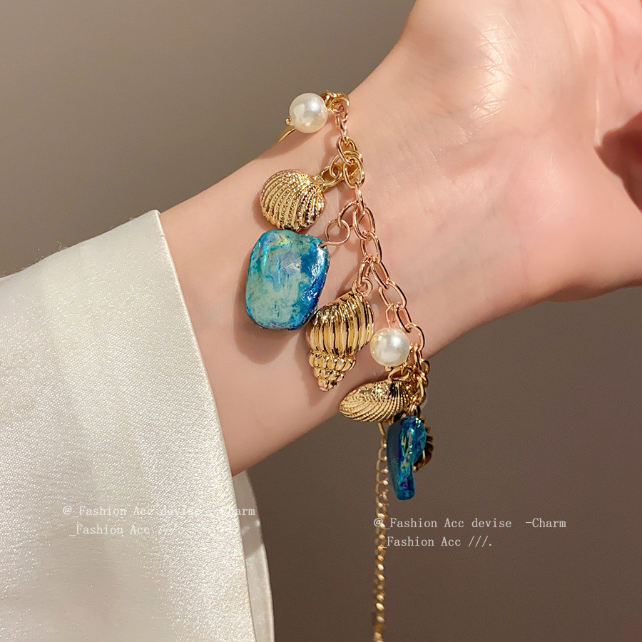 [จูวบิวตี้]สร้อยข้อมือมุกเปลือกหอยสังข์สไตล์วันหยุดชายทะเลแสงหรูหราแฟชั่นระดับไฮเอนด์ผู้หญิงวาดด้วยมือ