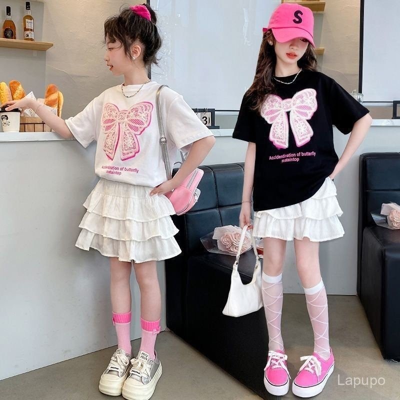 ชุดกระโปรงแฟชั่นสไตล์เกาหลีสำหรับเด็กผู้หญิง สำหรับเด็กกลางและใหญ่ ฤดูร้อน แฟชั่นใหม่ แขนสั้นพิมพ์โบว์และชุดกระโปรงสองชิ้น