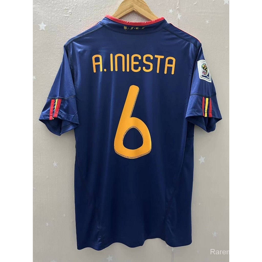 สเปน 2010 เสื้อฟุตบอลผู้เข้าชมย้อนยุคคุณภาพสูงช่อดอกไม้ที่กําหนดเอง INIESTA VAAG