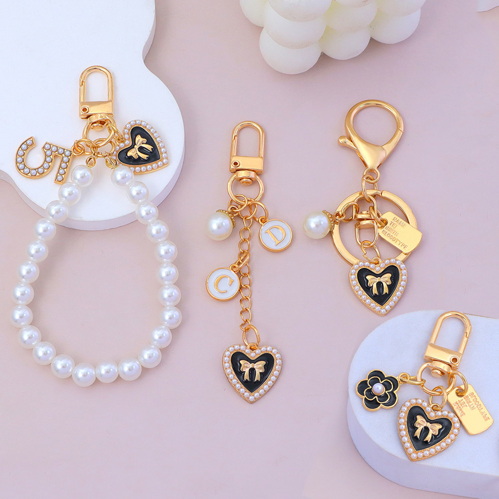 หวานเลียนแบบมุกหัวใจพวงกุญแจแฟชั่นโบว์ดอกไม้พวงกุญแจหูฟังกรณีจี้ของขวัญของที่ระลึก