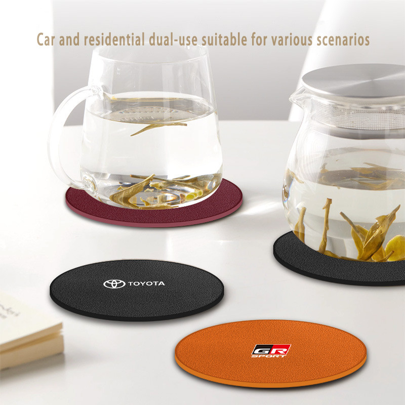 ตกแต่งบ้าน 1ชิ้น สำหรับ Toyota แผ่นรองแก้วน้ําในรถยนต์ หนังแผ่นรองแก้วน้ําในรถยนต์ แผ่นรองแก้วน้ำในรถ​​ กันลื่น แผ่นรองแก้วเครื่องดื่ม Toyota GR 86 Yaris Corolla Cross Altis Supra CHR Wish bZ4X Vios Sienta Avanza Fortuner Camry Hilux Revo Yaris ATIV Yaris Cross ส่งด่วน สั่งเลย