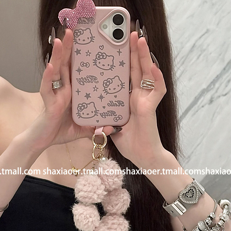 Huiwanju หนังสีชมพูโบว์ Kt cat สําหรับ iPhone16 โทรศัพท์มือถือกรณี ip15promax ผู้หญิง 14pro ใหม่ 13 anti-drop 15pro พรีเมี่ยมการ์ตูนตุ๊กตา