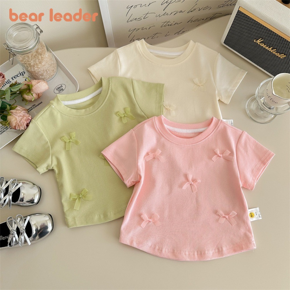 Bear Leader ฤดูร้อนใหม่คอกลมแขนสั้นสีทึบเสื้อผ้าเด็กผู้หญิงเวอร์ชั่นเกาหลีโบว์เสื้อยืดพื้นฐานด้านบน