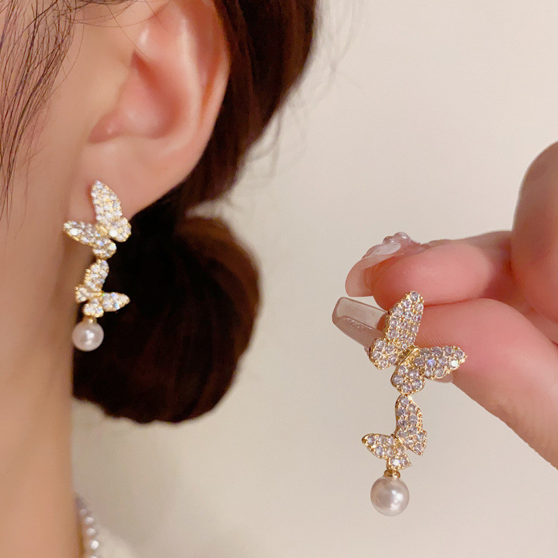แฟชั่นที่สวยหรูแสงหรูหราระดับไฮเอนด์เพทายผีเสื้อมุกพู่ต่างหูที่ดีงาม