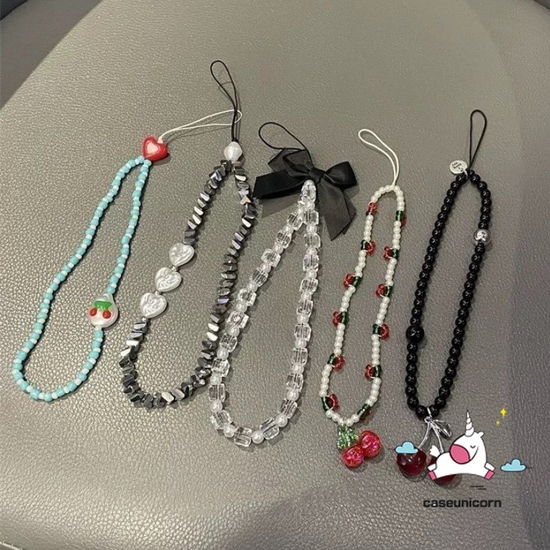 อุปกรณ์เสริมเคสโทรศัพท์สากลเชือกเส้นเล็กแบรนด์อินเทรนด์สร้างสรรค์โบว์น่ารักเชอร์รี่การ์ตูนลูกปัดลูกอมรักหัวใจเย็นสาวสร้อยข้อมือพวงกุญแจตกแ