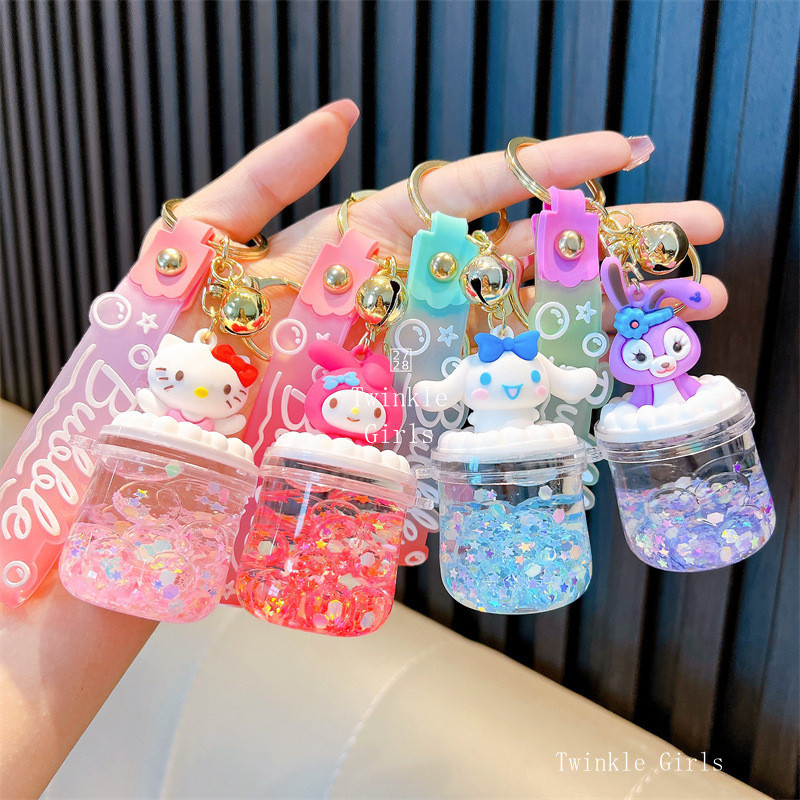 Kuromi Cinnamoroll ดูดทรายเป็นน้ำมันขวดลอยพวงกุญแจ Hello Kitty Melody กระเป๋าหนังสือจี้พวงกุญแจคู่รักน่ารัก
