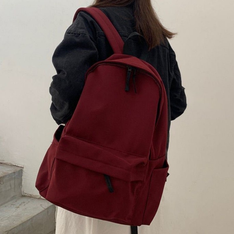 กระเป๋าเป้สะพายหลังความจุขนาดใหญ่แฟชั่นญี่ปุ่นสําหรับเด็กผู้หญิงสีทึบย้อนยุคเรียบง่ายนักเรียนอินเทรนด์ใหม่ลําลองอเนกป