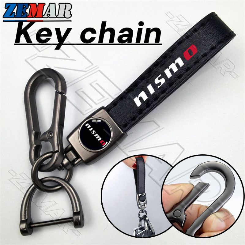 Nissan Nismo พวงกุญแจหนังโลหะ พวงกุญแจรถจักรยานยนต์ พวงกุญแจแขวนแฟชั่นระดับไฮเอนด์ รูปแบบการพิมพ์ Ni