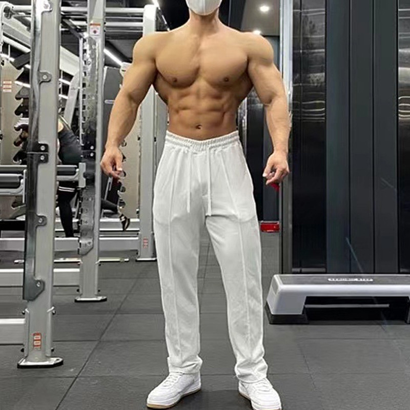กางเกงขาตรงทรงหลวมผู้ชายผ้าฝ้ายกีฬาลําลองเรียบง่ายสบายกางเกงระบายอากาศ