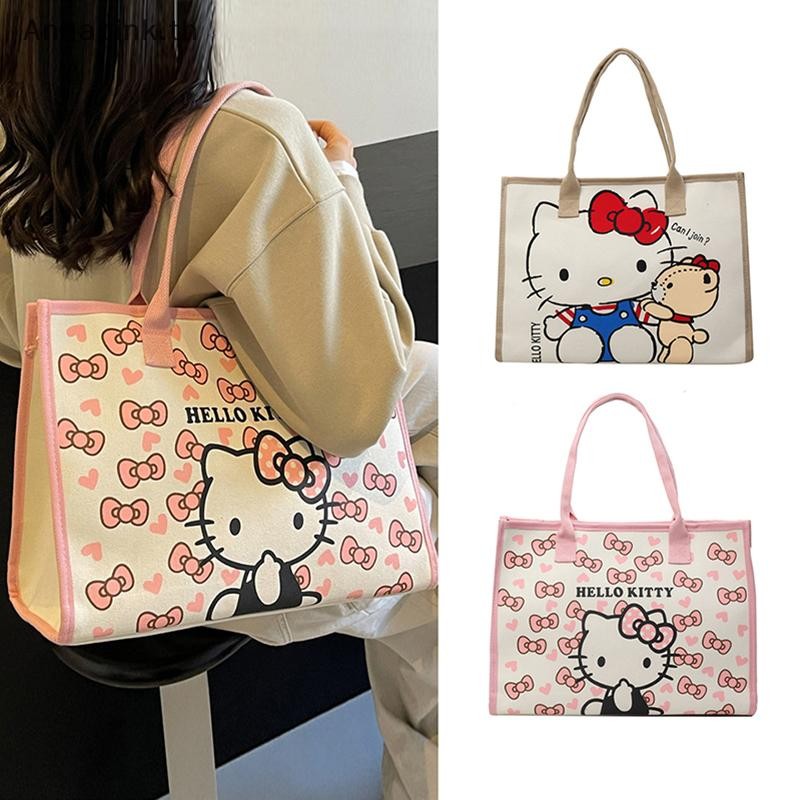 Annapink.th Hello Kitty All Match กระเป๋าผ้าใบผู้หญิง Commuter กระเป๋าสะพายสาวนักเรียนความจุขนาดใหญ่กระเป๋านักเรียนการ์ตูน EN