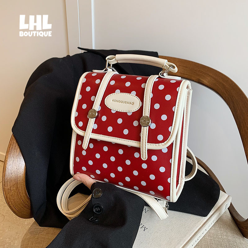 LHL BOUTIQUE Niche กระเป๋าสไตล์วิทยาลัยผู้หญิงสีตัดกันลายจุดกระเป๋าเป้สะพายหลังแนวโน้มแฟชั่นกระเป๋านักเรียนอเนกประสงค์