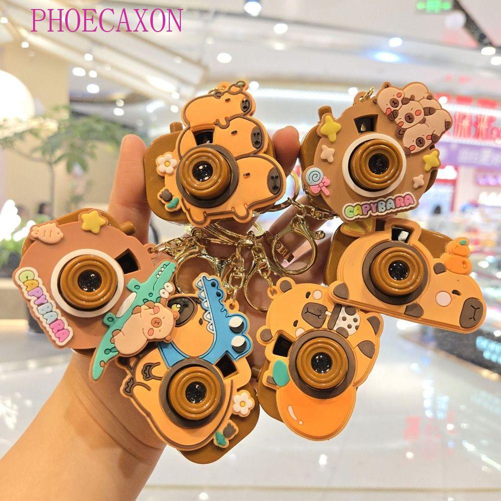 PHOECAXON Capybara พวงกุญแจ, กล้องโปรเจคเตอร์ Kawaii Kapybara จี้, Creative คีย์อุปกรณ์เสริมกระเป๋านักเรียนเครื่องประดับซิลิโคน Capybara ตุ๊กตาสาวของขวัญ ราคา ถูกที่สุด ดีลบีเคเค