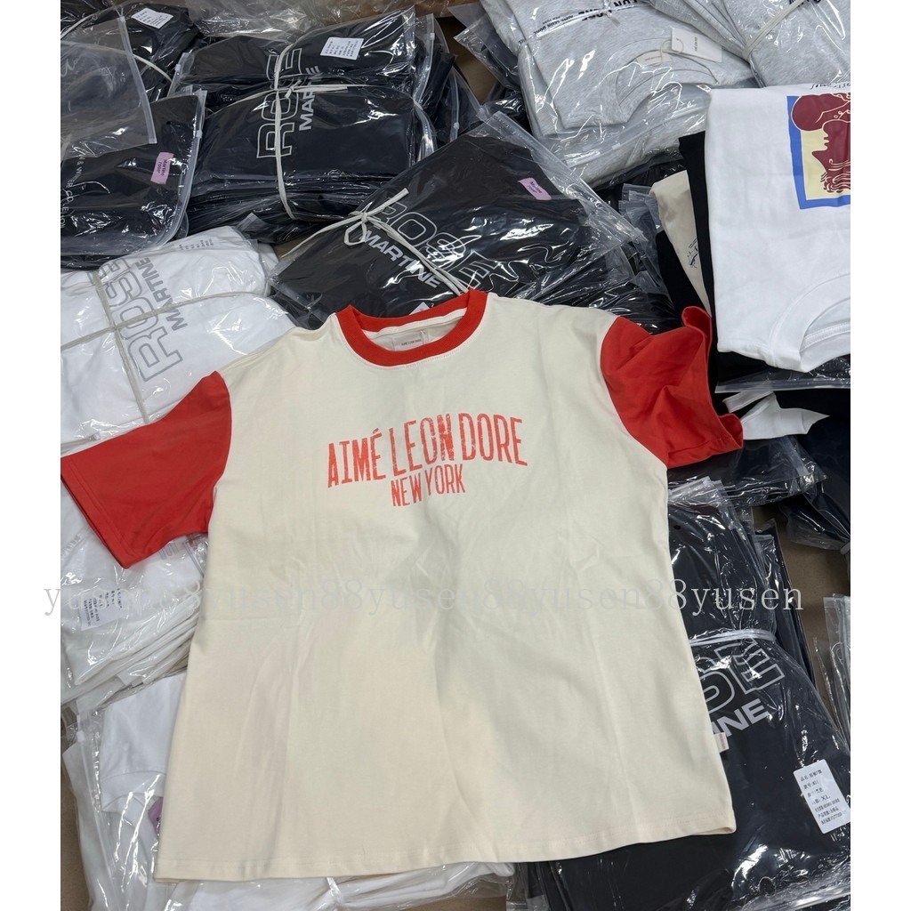 Ai8e L8on D8re เสื้อยืดแขนสั้นผ้าฝ้ายคอกลมพิมพ์ลายเงินสด