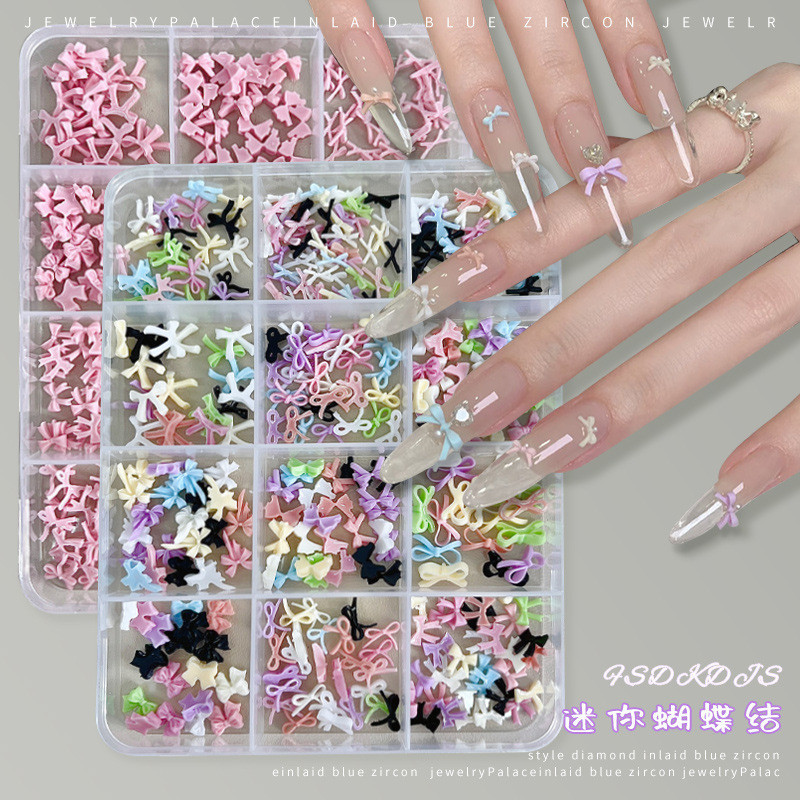 อะไหล่โบตกแต่งเล็บ  คละสี 12 ช่อง คละขนาด สีขาว และชมพู ประดับด้วยเพชรเทียม
