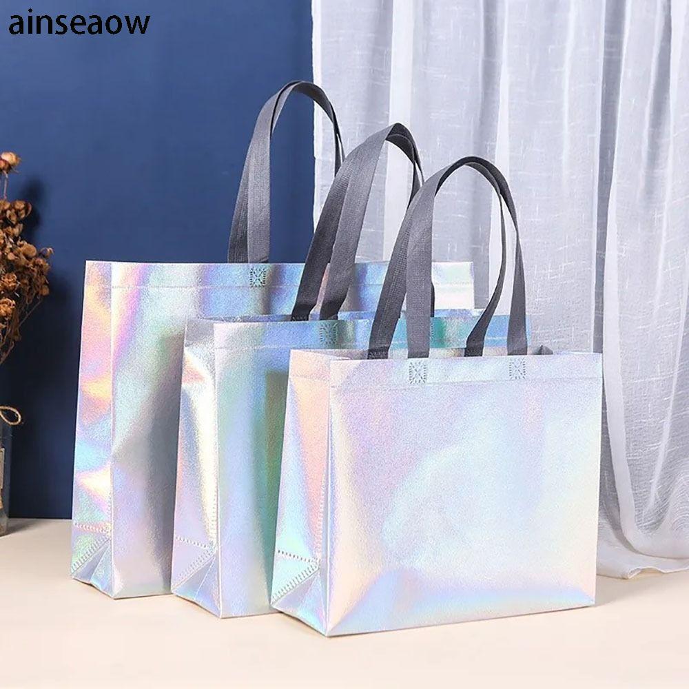 AINSEOW กระเป๋าโท้ตไม่ทอ 1 ชิ้น, ร้านขายเสื้อผ้ากระเป๋าช้อปปิ้งความจุขนาดใหญ่, ถุงของขวัญเลเซอร์กระเป๋าสะพายนํากลับมาใช้ใหม่ได้