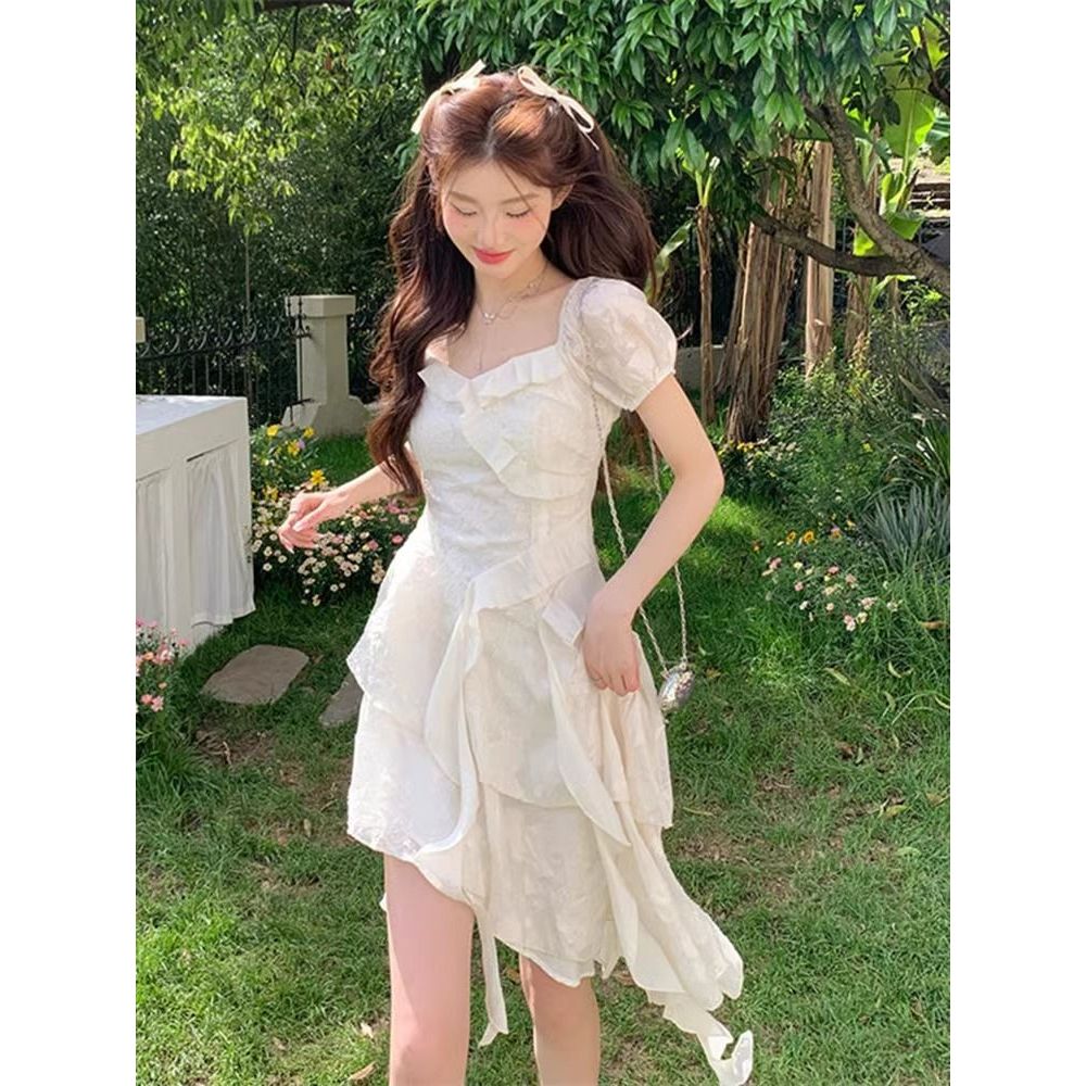 2026 ใหม่เกาหลีFairy Ruffle Hemไม่สมมาตรชุดสีขาวผู้หญิงฤดูร้อนไหลTieออกแบบติดตั้งเอวSlim Fitวันที่First Love Casual Commute