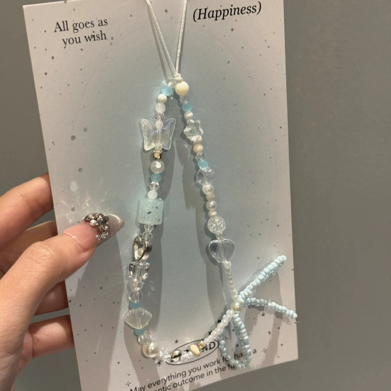 INS คริสตัลสีฟ้าดอกไม้ Bowknot ลูกปัดจี้โทรศัพท์ Charm สายคล้องคอสําหรับ iPhone Accessrioes Lanyard สาวสไตล์โซ่