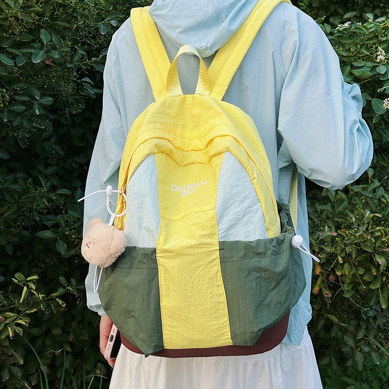 เด็กแฟชั่นสบายๆสไตล์ที่เรียบง่ายกระเป๋าเป้สะพายหลังสาวอเนกประสงค์เดินทางน้ําหนักเบากระเป๋าเป้สะพายหล