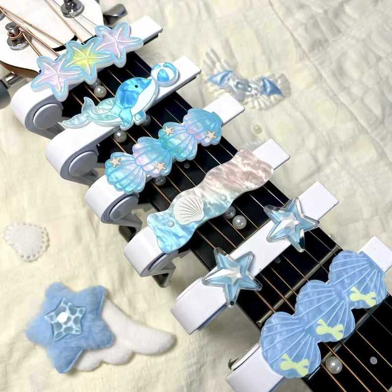ฤดูร้อนสดประณีต Ocean Star อะคูสติกกีตาร์ไฟฟ้า Transpose คลิปเสียงคลิป Ukulele Capo น่ารักสีขาว X1110