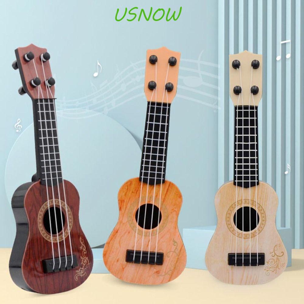 USNOW อูคูเลเล่คลาสสิกสําหรับผู้เริ่มต้นกีตาร์เด็กทนทาน 4 Strings Stringed Instrument ของเล่นความบันเทิง Montessori ของเล่นเด็กของขวัญเด็กกีตาร์ขนาดเล็กของเล่น