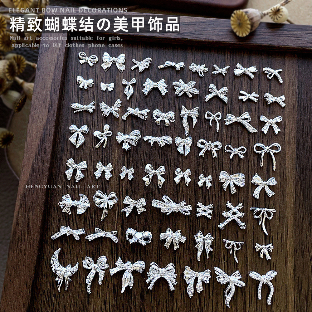 10 ชิ้นขายร้อน Bowknot อุปกรณ์แต่งเล็บ All-match Silver Hollow ริบบิ้น Bow Tie โลหะผสมสวมใส่เล็บอุปกรณ์เสริม
