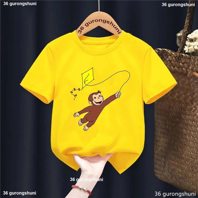 2026Curious George ลิงการ์ตูนพิมพ์สีเหลืองเสื้อยืดผู้หญิง/ชายตลก Kawaii เด็กเสื้อผ้าฤดูร้อนเสื้อเสื้