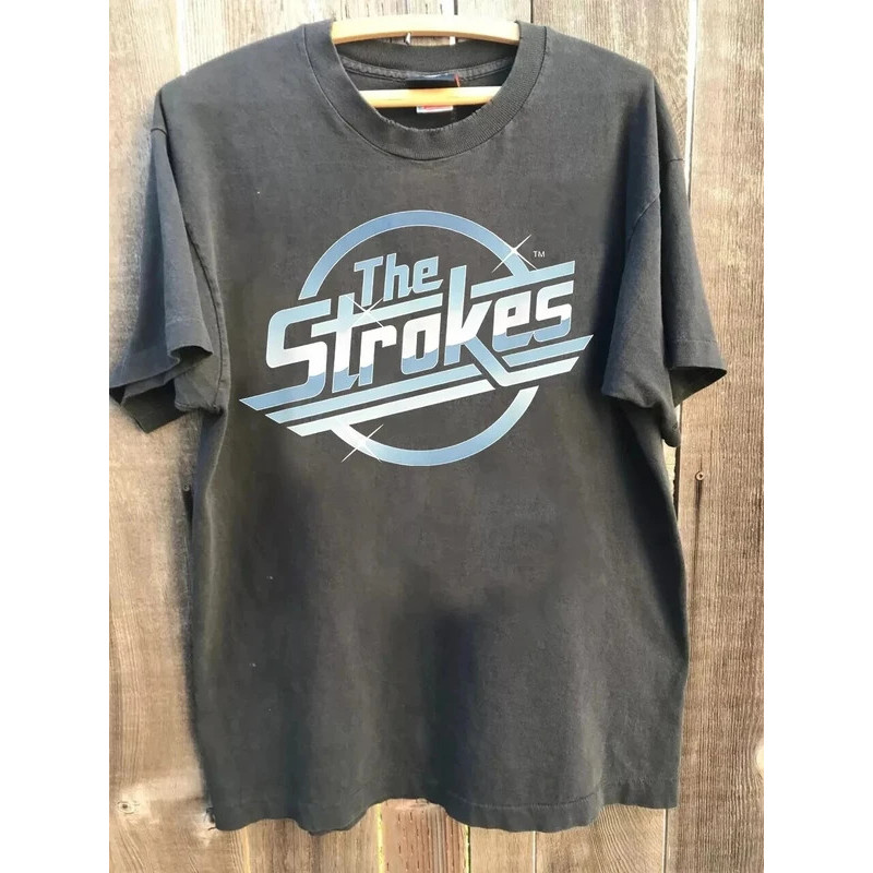 เสื้อยืดผู้ชายยอดนิยมของวง The Strokes Band สำหรับงานเทศกาลดนตรีปี 2026 เสื้อยืดแขนสั้นผ้าฝ้ายทรงโอเวอร์ไซส์สไตล์ Y2k แฟ