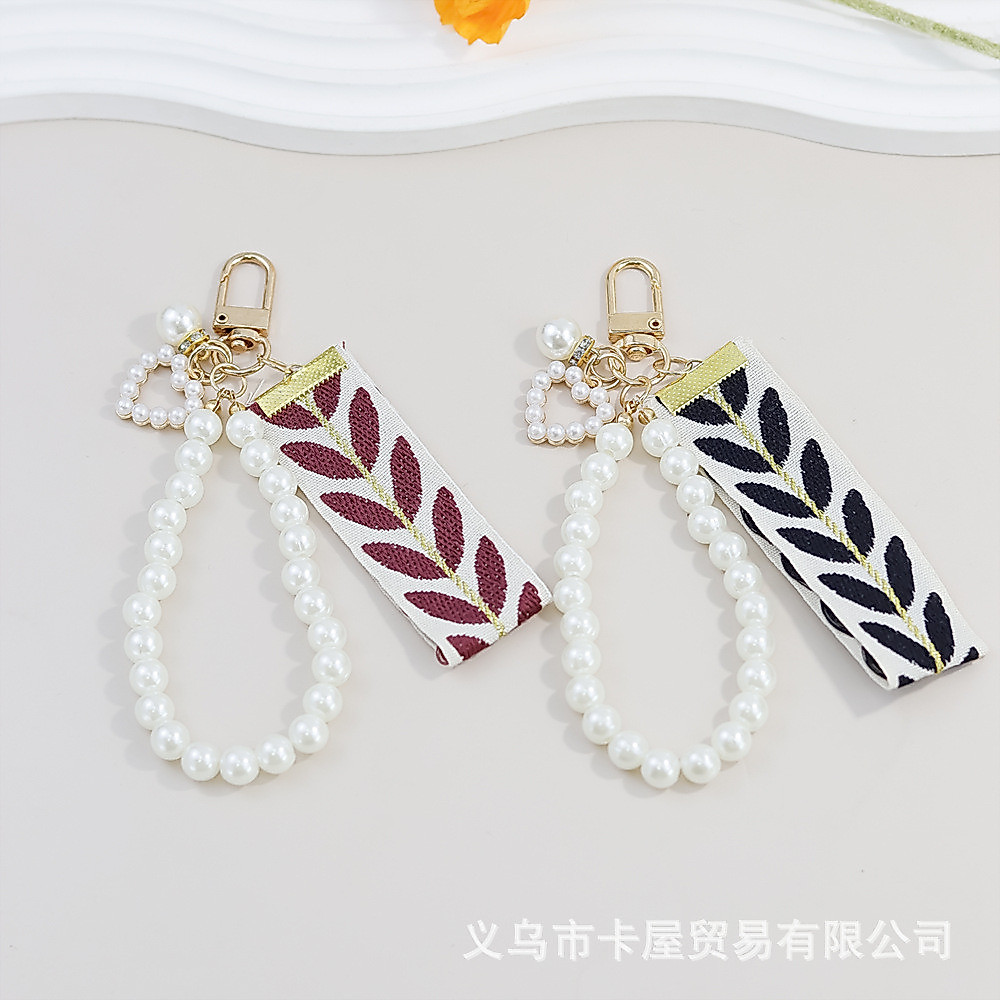 Pearl Love Ribbon พวงกุญแจเชือกเส้นเล็กโทรศัพท์มือถือ Leaf Ribbon จี้รถกระเป๋า