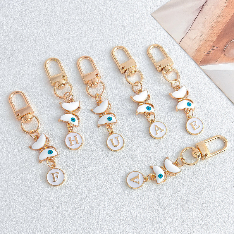 Evil Eye พวงกุญแจตัวอักษรผีเสื้อ Lucky Amulet พวงกุญแจตัวอักษรส่วนบุคคลกระเป๋า Charm อุปกรณ์เสริมไอเดียของขวัญ