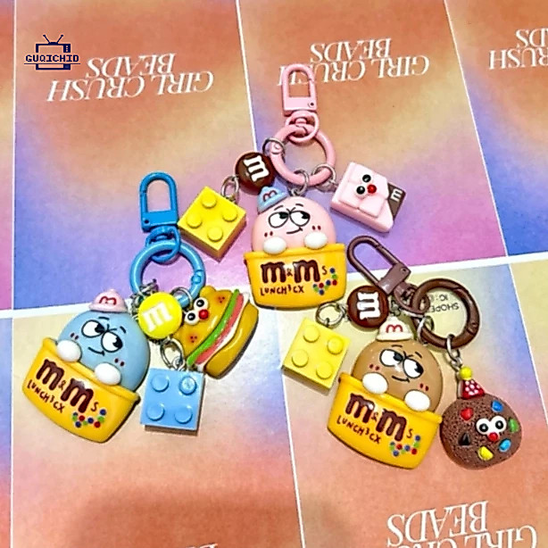 พวงกุญแจ / พวงกุญแจ / พวงกุญแจห้อยกระเป๋า M&M จี้โทรศัพท์ตุ๊กตา M Bean การ์ตูน บล็อกบิสกิต เคสหูฟัง จี้สีสันสดใส จี้ตลก