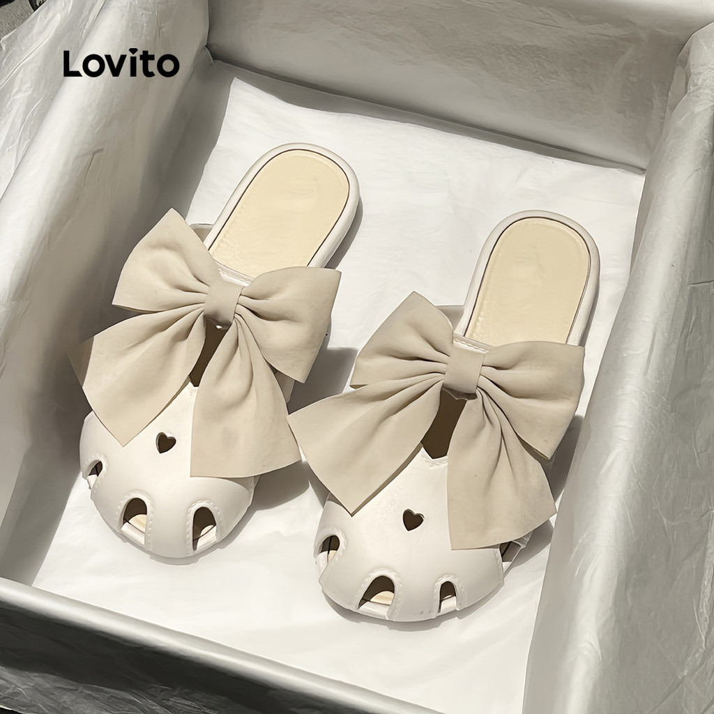 Lovito  รองเท้าแตะแฟลตแบบลําลอง หัวรองเท้าฉลุลาย ประดับโบว์หัวใจ สีขาวงาช้าง สําหรับผู้หญิง LFA112016