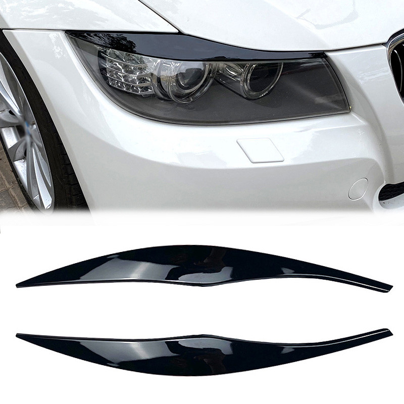 2 ชิ้นเคลือบเงาสีดําไฟหน้าโคมไฟคิ้วฝาครอบสติกเกอร์ Trim สําหรับ BMW 3 Series E90 E91 ซีดาน Touring 2