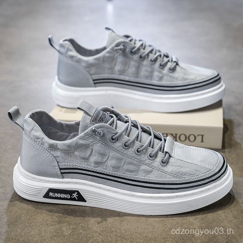 รองเท้าผู้ชายสไตล์ใหม่รองเท้าผ้าใบระบายอากาศอินเทรนด์ทุกการแข่งขันรองเท้าแบนขี้เกียจรองเท้าผ้าแบบสวม