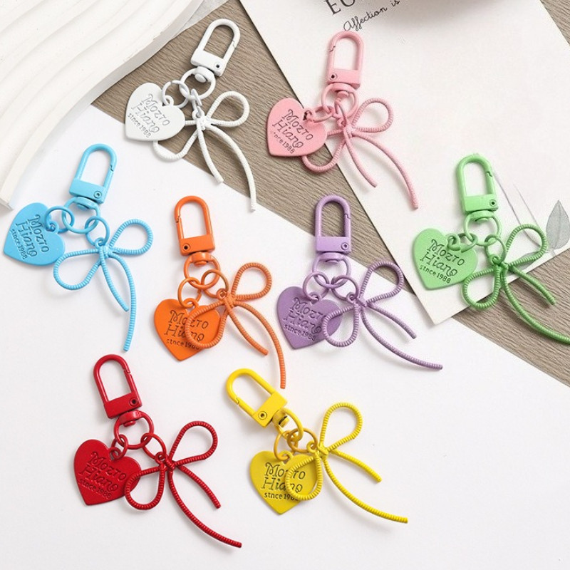 แฟชั่น Simple Bowknot Heart พวงกุญแจสําหรับผู้หญิงสาวน้ําหนักเบาสไตล์โทรศัพท์มือถือหูฟังอุปกรณ์เสริมกระเป๋าจี้ตกแต่ง Perfect สําหรับของขวัญเพื่อนส่วนตัว