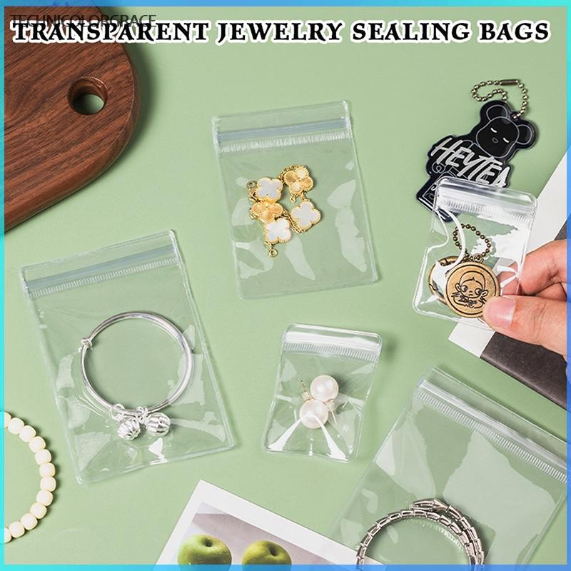 Technicolorgrace 100 ชิ้นเครื่องประดับกระเป๋ากระเป๋าใส PVC Anti-Oxidation ต่างหูจี้สร้อยคอสร้อยข้อมื