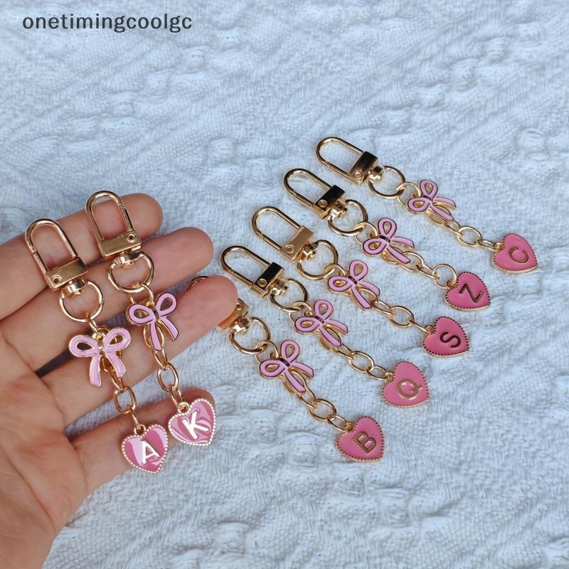 ตัวอักษรสร้างสรรค์โลหะโบว์สีชมพูพวงกุญแจแฟชั่น AZ 26 ตัวอักษรพวงกุญแจ Charms โทรศัพท์มือถือ Key Holders กระเป๋าอุปกรณ์เสริมของขวัญ