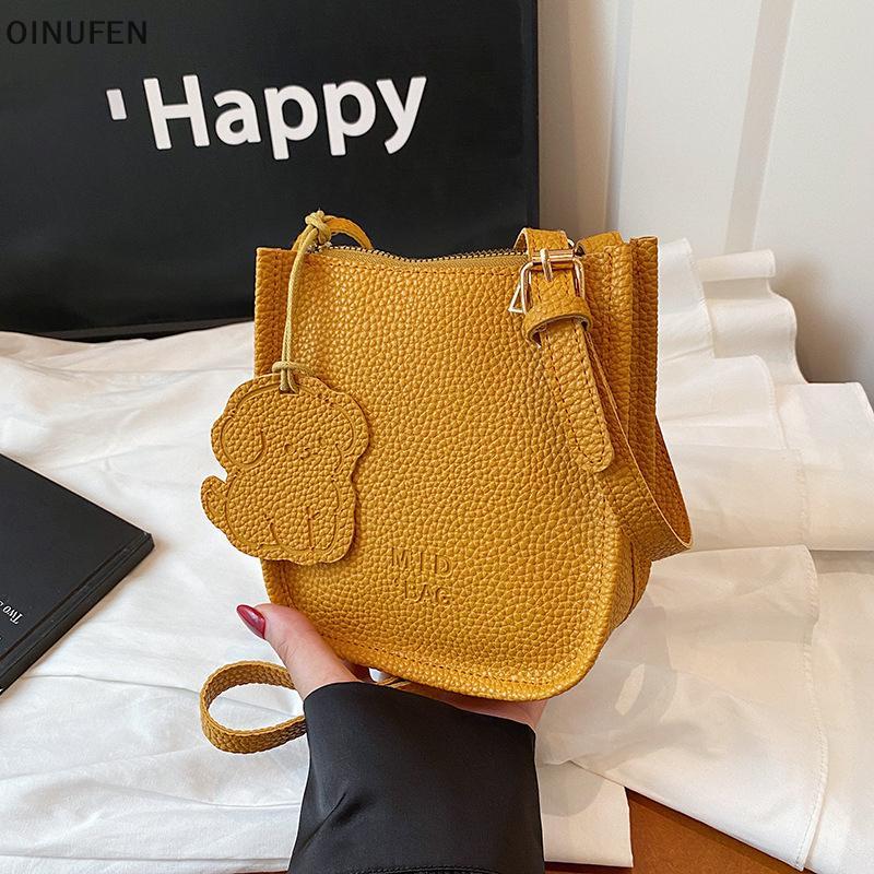 ONU กระเป๋าสะพายข้างหนัง PU สไตล์เกาหลีเรียบหรูกะทัดรัด พร้อมกระเป๋าคล้องคอการ์ตูนแบบFEI