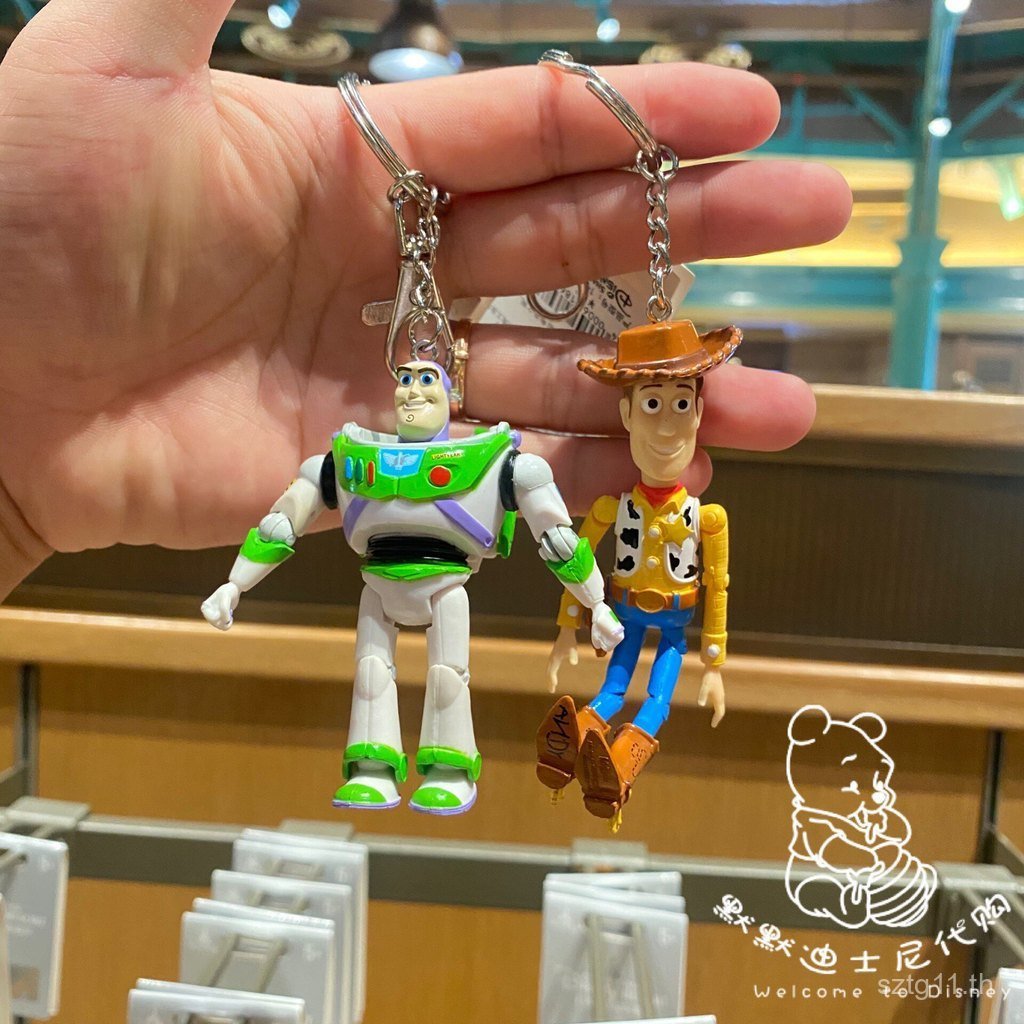 พร้อมสต็อก พวงกุญแจ Disneyland Buzz Lightyear Woody พวงกุญแจเคลื่อนย้ายได้ ข้อต่อพวงกุญแจเคลื่อนย้าย