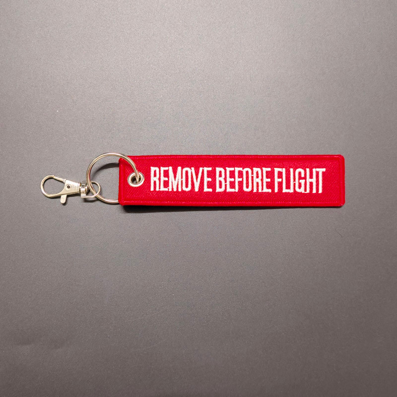 BEFORE FLIGHT Picking Up Pendant Aviation Red Warning Slogan เย็บปักถักร้อย REMOVE BEFORE FLIGHT พวง