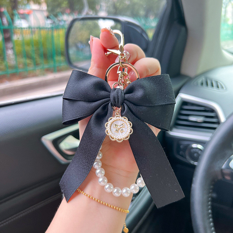 สีดํา Pearl Bow พวงกุญแจกระเป๋า Charm พวงกุญแจอุปกรณ์เสริมสําหรับผู้หญิงกระเป๋าถือ Charm พวงกุญแจของขวัญ ZH1092