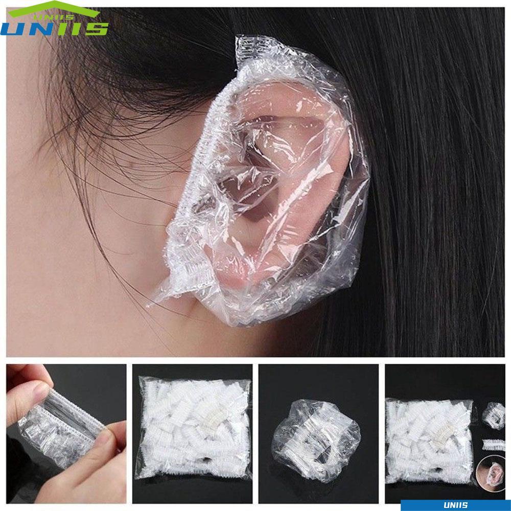 UNIIS ฝาครอบหูแบบใช้แล้วทิ้งโปร่งใส Onetime Bath Shower ทําความสะอาดเครื่องมือย้อมผมหมวกป้องกันหู