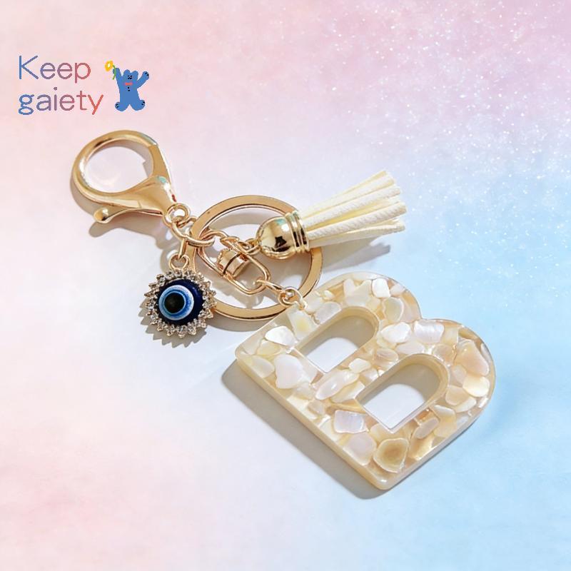 [Kpt-t] 1 ชิ้นน่ารัก Evil Eye sel จี้พวงกุญแจตัวอักษรครีมสี 26 เริ่มต้นพวงกุญแจสําหรับผู้หญิงสาวกระเป๋าเครื่องประดับรถ Trinket [ใหม่]