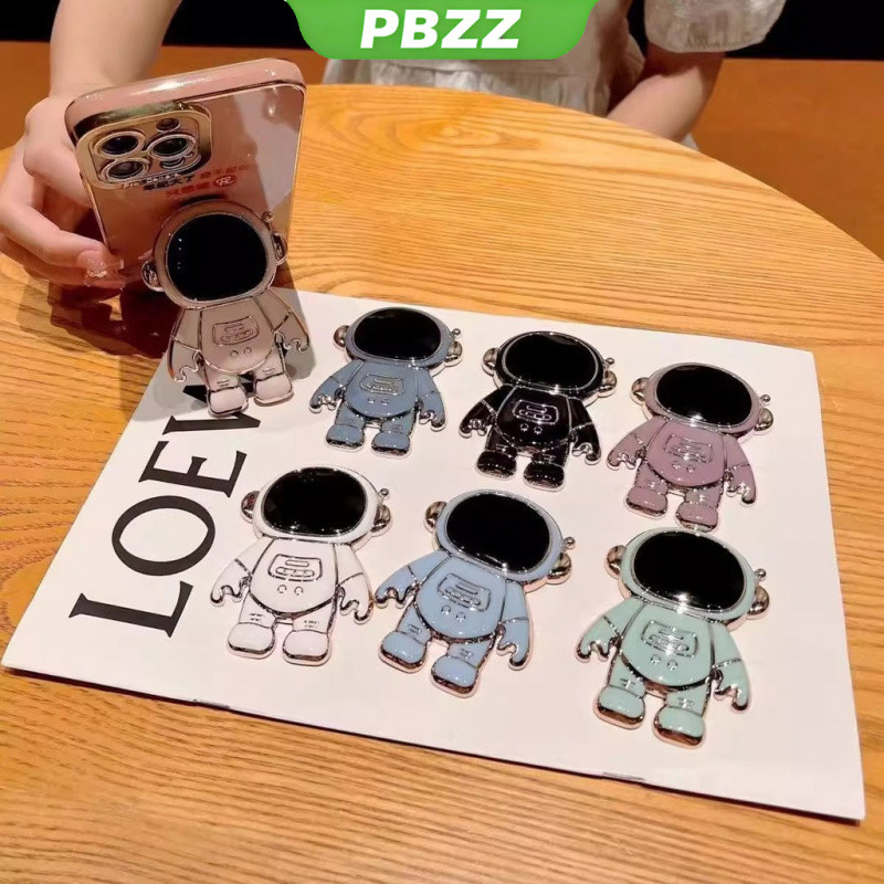 PBZZ สำหรับโทรศัพท์มือถือที่มีที่วาง ที่วางเครื่องสำอางรูปการ์ตูนนักบินอวกาศ ขาตั้งหมุนได้ 360 องศา แหวนหรูหราพับได้ อุปกรณ์เสริมโทรศัพท์มือถือใหม่