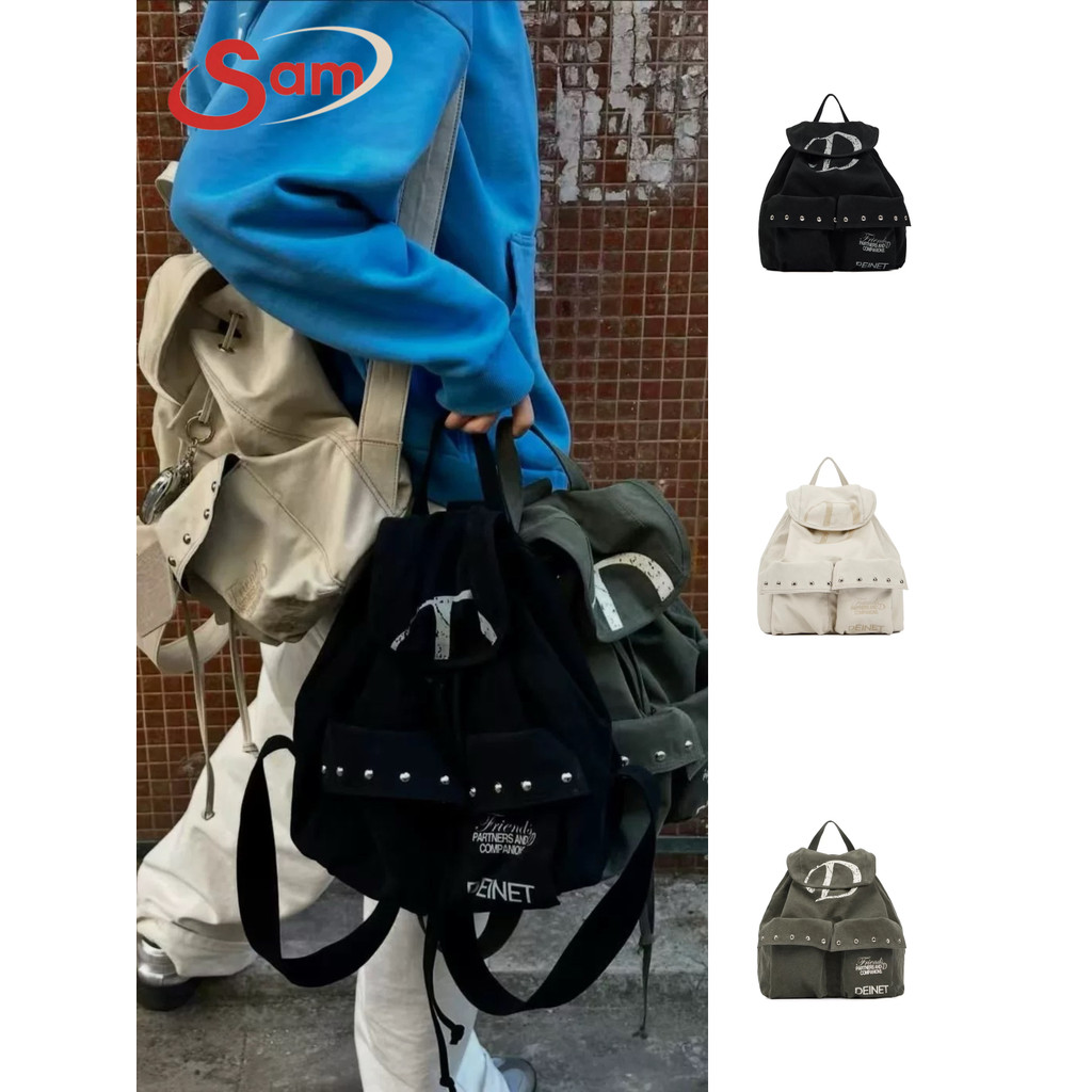 กระเป๋า Niche Deinet เกาหลี 2025 กระเป๋าเป้สะพายหลัง Drawstring Pocket Rivet ผ้าใบกระเป๋าเป้สะพายหลั