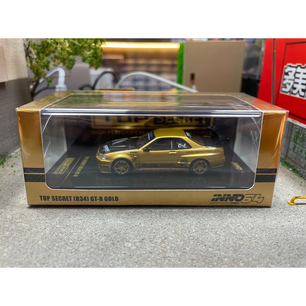 INNO64 Nissan GT-R (R34) TOP SECRET GOLD ใหม่เอี่ยมยังไม่ได้เปิดพร้อมกล่องเดิมชิ้นส่วนทองสีดําฝาครอบ