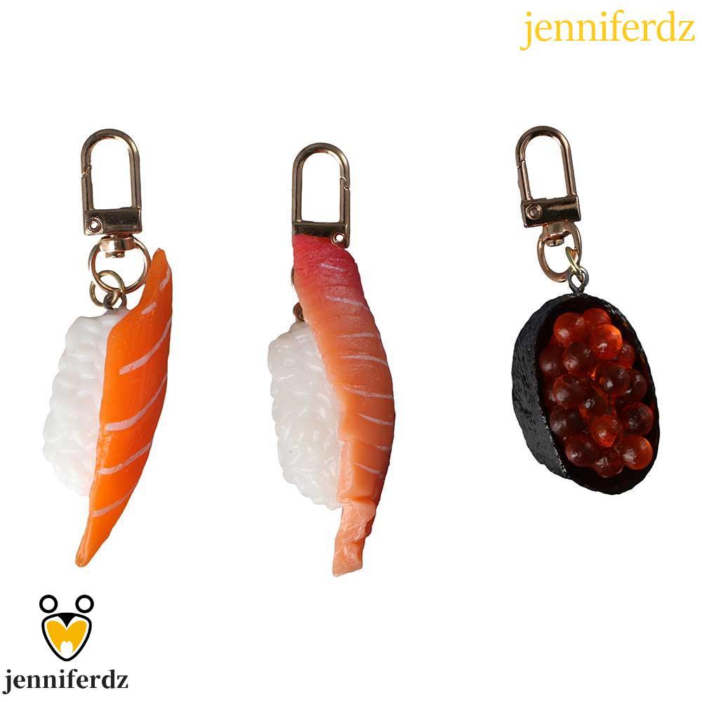 JENNIFERDZ จําลองซูชิพวงกุญแจบุคลิกภาพของขวัญญี่ปุ่นอาหารกระเป๋าจี้ปลาแซลมอน Sea Urchin ซูชิกระเป๋าจ